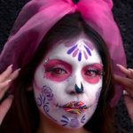 Vibrant face paint capturing the beauty and tradition of Dia de los Muertos with intricate details and bold colors.