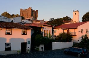 Scenic view of Bragança Castle and traditional houses at sunset, highlighting Portuguese architecture.